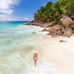 Image showing Woman enjoying Anse Patates picture perfect beach on La Digue Island, Seychelles.