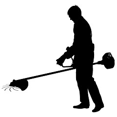Image showing Silhouette worker of a garden cuts off  grass. 