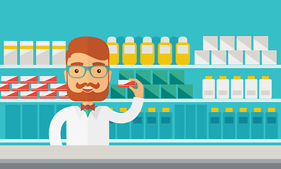 Image showing Young  pharmacy chemist man standing in drugstore. 