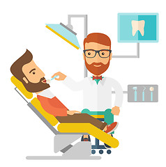 Image showing Dentist man examines a patient teeth in the clinic