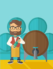 Image showing Wine maker inspecting wine from barrel.