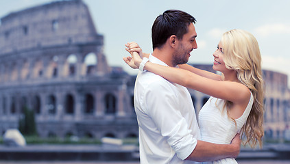 Image showing happy couple hugging over coliseum