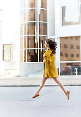 Image showing happy young woman or teenage girl on city street