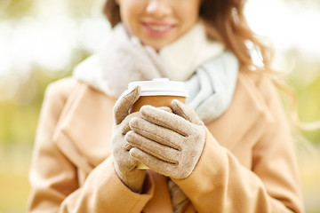 Image showing close up of happy woman with coffee in autumn park