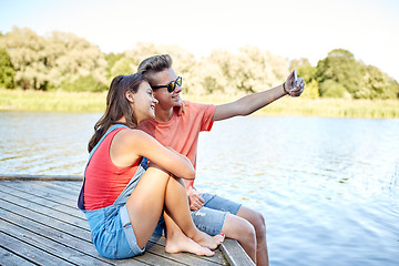 Image showing happy teenage couple taking selfie on smartphone