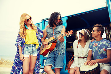 Image showing happy hippie friends playing music over minivan