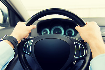 Image showing close up of man driving car with computer screen
