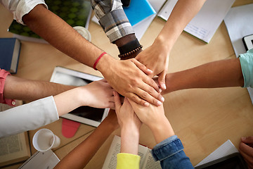 Image showing group of international students with hands on top