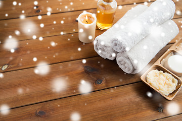 Image showing bath towels, candle, massage oil and body scrub