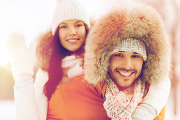 Image showing happy couple having fun over winter background