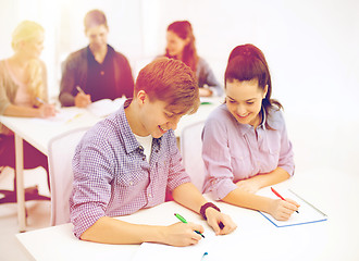 Image showing smiling students with notebooks at school