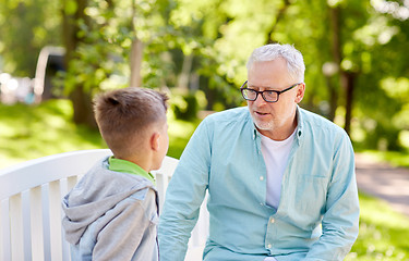 Image showing grandfather and grandson talking at summer park