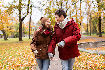 Image showing happy young couple walking in autumn park