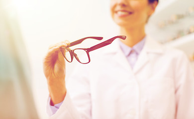 Image showing close up of optician with glasses at optics store