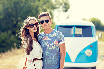 Image showing smiling young hippie couple over minivan car