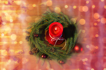 Image showing fir branch wreath with candle on wooden table