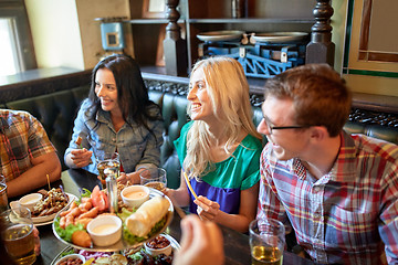 Image showing friends dining and drinking beer at restaurant