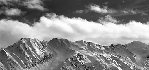 Image showing Black and white panoramic view on snow winter mountains and sunl