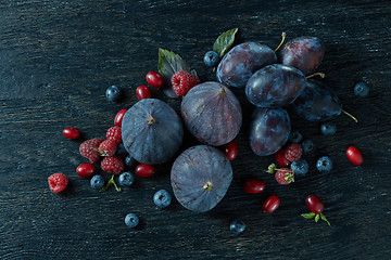 Image showing ripe figs and berries with a bunch of basil