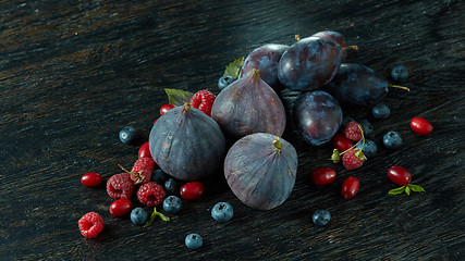 Image showing Healthy food. A lot of ripe juicy berries and figs