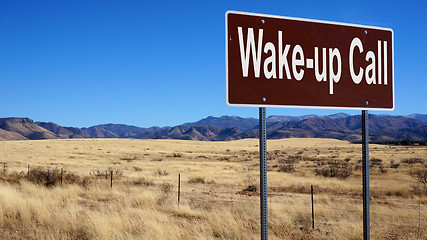 Image showing Wake up Call brown road sign