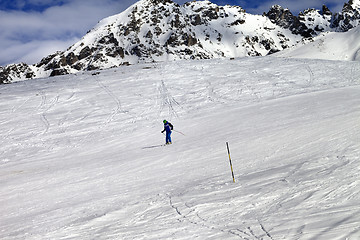 Image showing Skier on ski slope at sun winter day