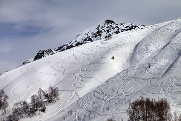 Image showing Off-piste slope with traces from skis and snowboards