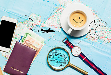 Image showing Preparation for travel concept - map, magnifying glass, cup of coffee, notepad, phone