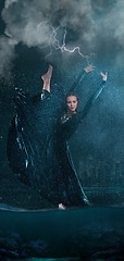 Image showing The young beautiful modern dancer dancing under water drops