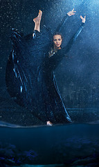 Image showing The young beautiful modern dancer dancing under water drops