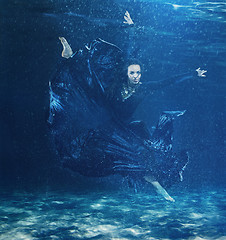 Image showing The young beautiful modern dancer dancing under water drops