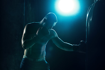 Image showing Male boxer boxing in punching bag