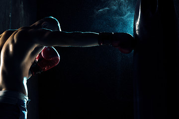 Image showing Male boxer boxing in punching bag
