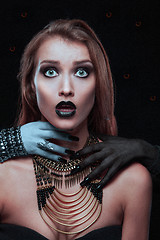 Image showing Pretty gothic woman with hands of vampire on her neck