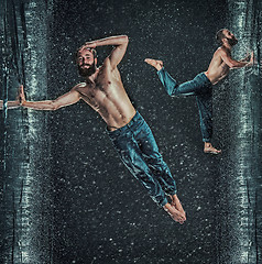 Image showing The male break dancer in water.