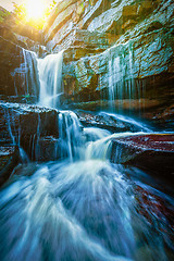 Image showing Tropical waterfall with sun rays