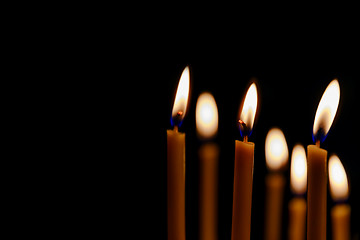 Image showing bright candles in dark