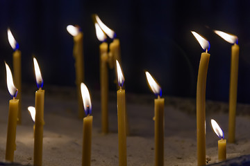 Image showing bright candles in dark