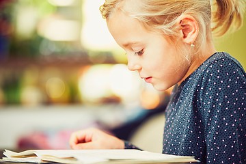 Image showing Girl is doing homework