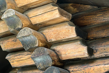 Image showing Fragment of the wall executed from processed natural round logs.