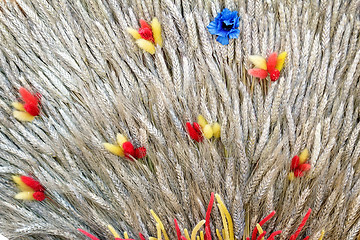 Image showing Decoration of artificial flowers and ears of corn.