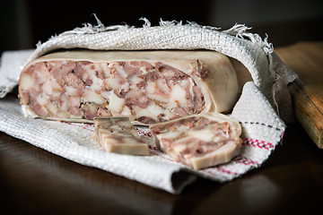 Image showing Appetizer of meat wrapped in a napkin.