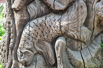 Image showing The figure of a fish carved on the tree trunk.