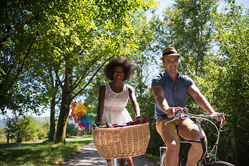 Image showing Young multiethnic couple having a bike ride in nature