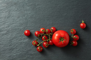 Image showing Tomatoes bunch on a black background