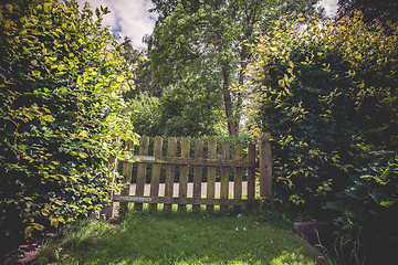 Image showing Wooden gate in a green garden