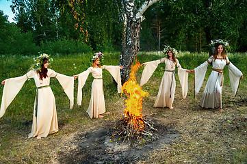 Image showing Beautiful women with flower wreath near bonfire