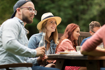 Image showing happy friends having dinner at summer garden party