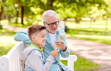 Image showing old man and boy eating ice cream at summer park