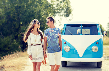 Image showing smiling young hippie couple over minivan car